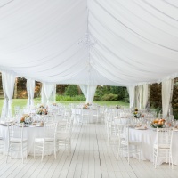 Outdoor wedding reception in tent